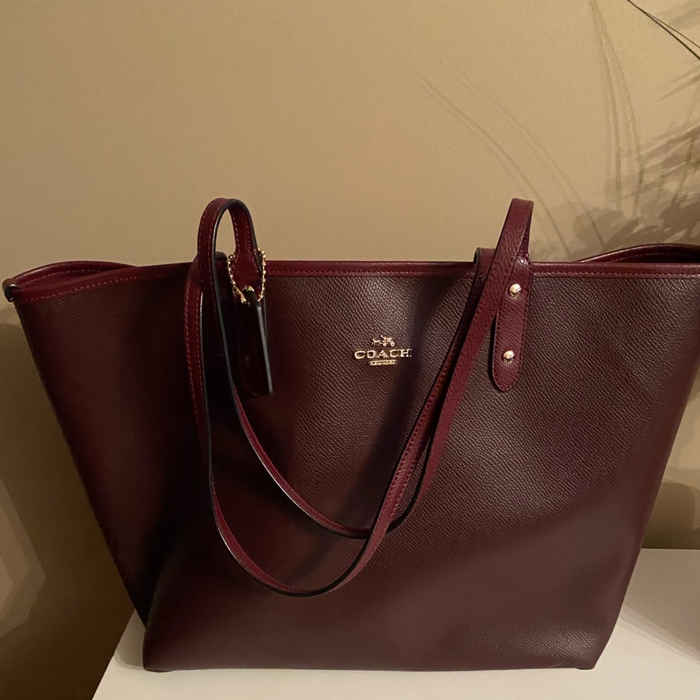 New Coach pvc burgundy bag, carried maybe twice comes with large cosmetic bag..